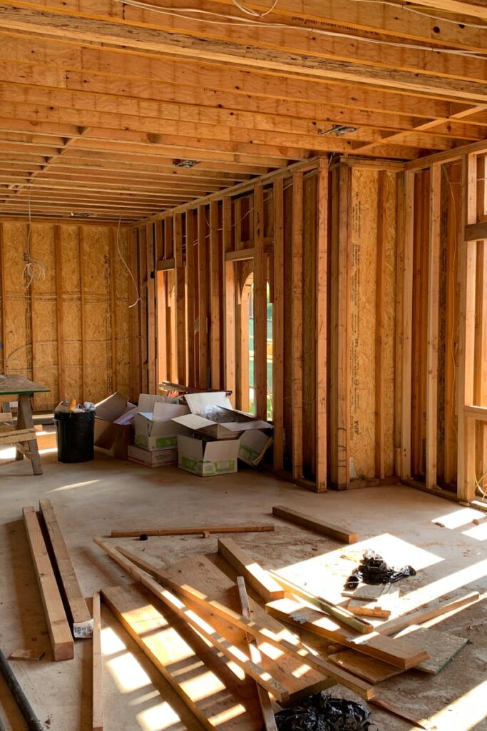 Sunlit interior with wood framing, showcasing home construction progress.